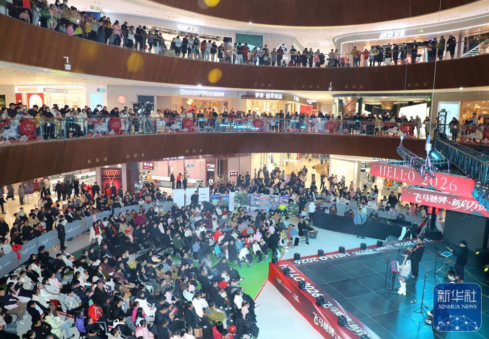 ↑ 1月1日，人们在河南省南阳市一家商业城内观看迎新年演出。新华社发（高嵩摄）